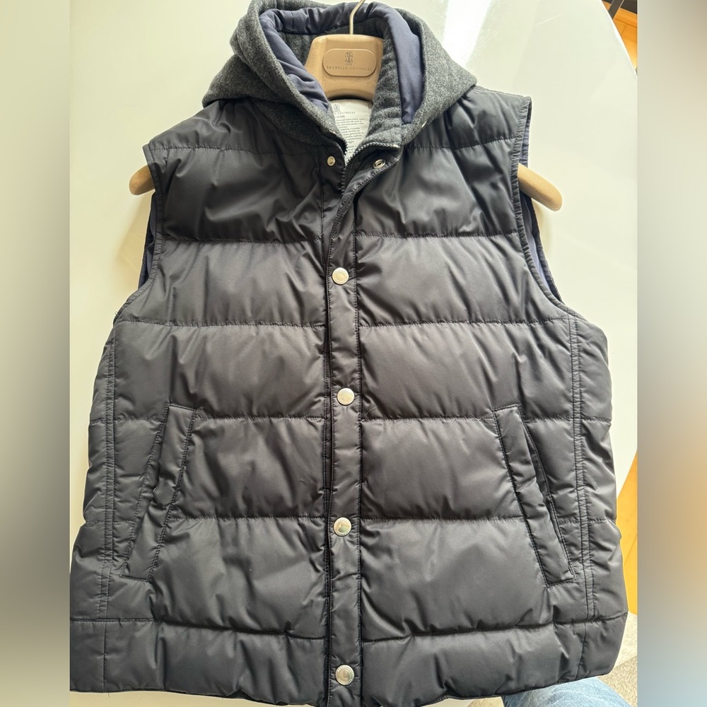 Brunello Cucinelli navy vest with cashmere hood, zip and button closure.